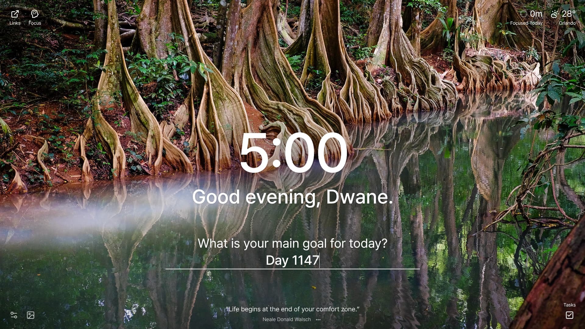 A tranquil scene featuring a calm body of water reflecting the surrounding trees with exposed roots, creating a mirror-like effect. The location is Indian River, Dominica.