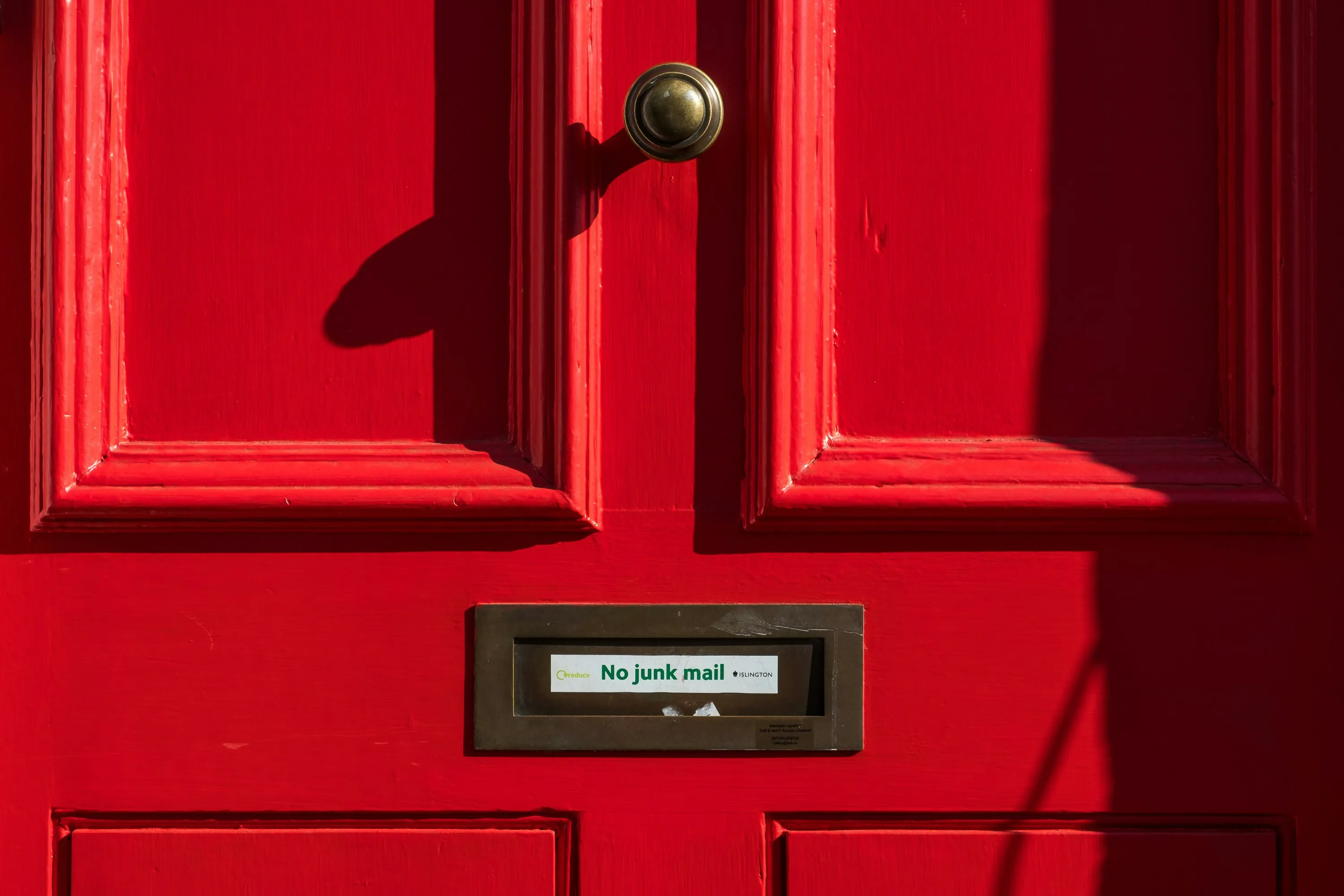 A door with a blocked mailbox witht he text no spam. Photo by Pau Casals on Unsplash