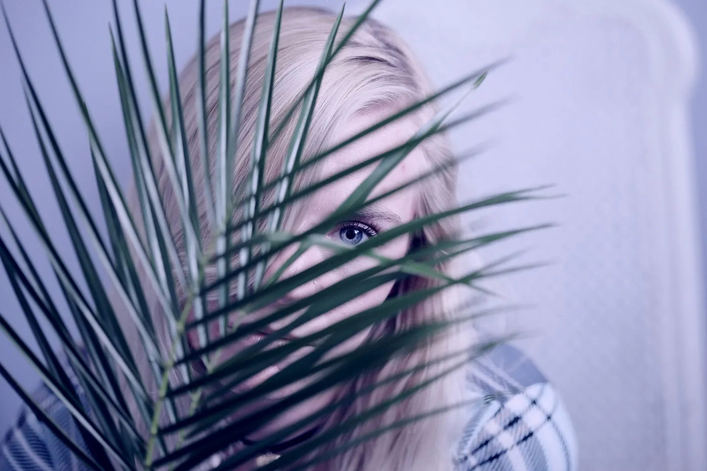 a person hiding behind a plant - Photo by Alexander Grey on Unsplash