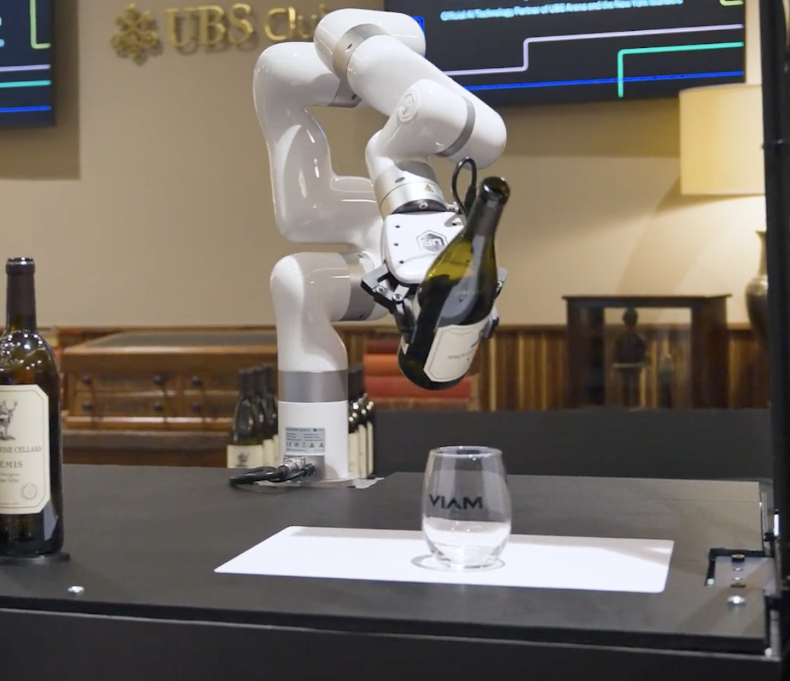 Robot arm pouring water into a glass