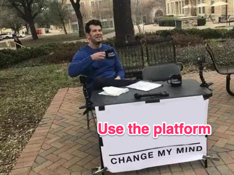 Screenshot of a man sitting at a table in a park with the banner Change my mind