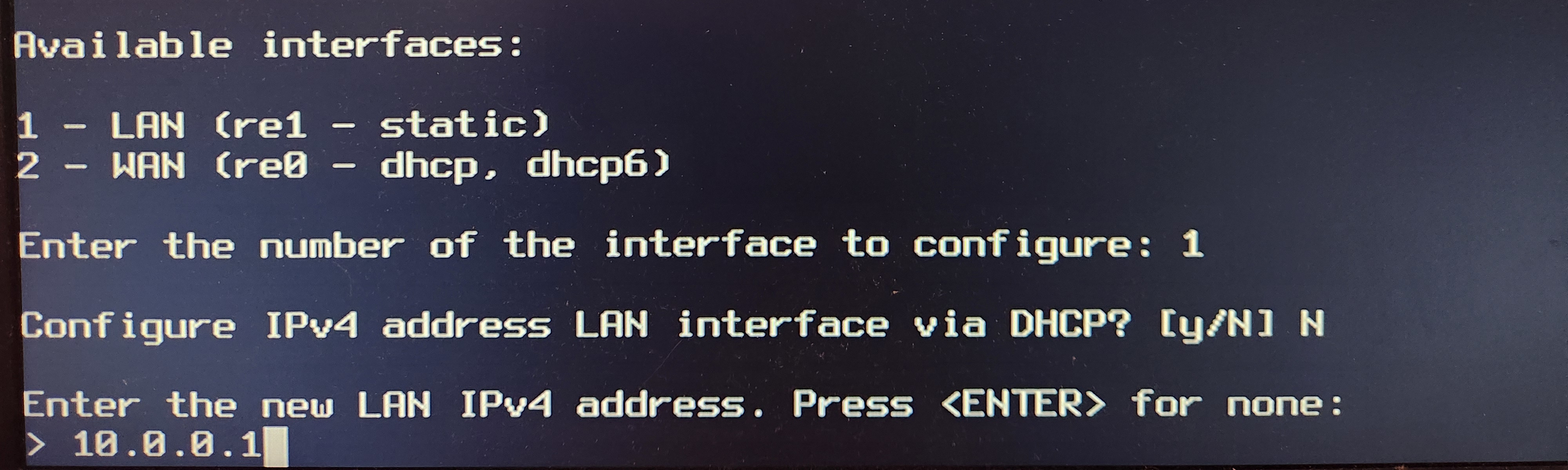OPNsense CLI showing the command to assign 10.0.0.1 to the LAN interface