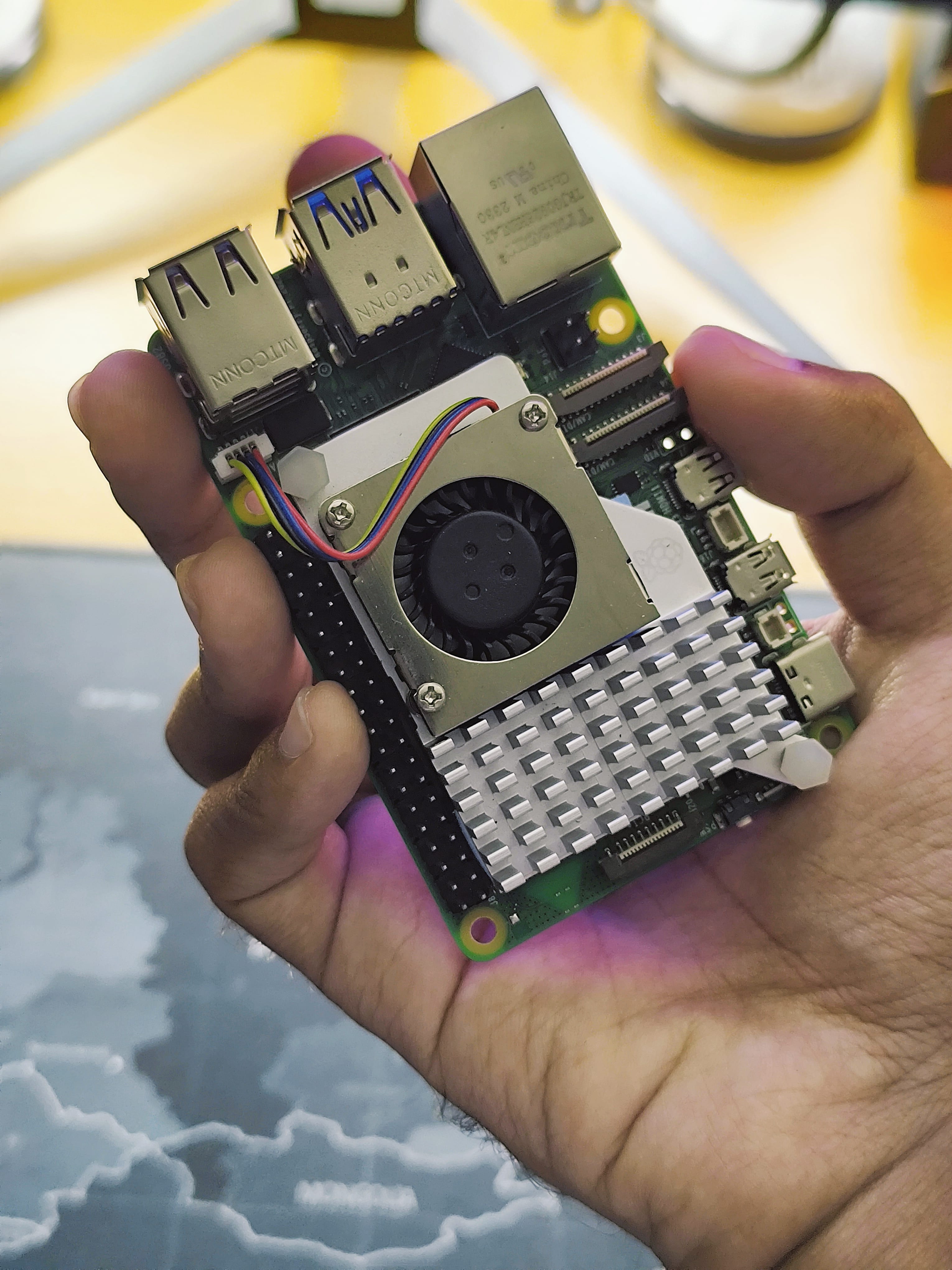 Photo of a person holding a Raspberry Pi 5