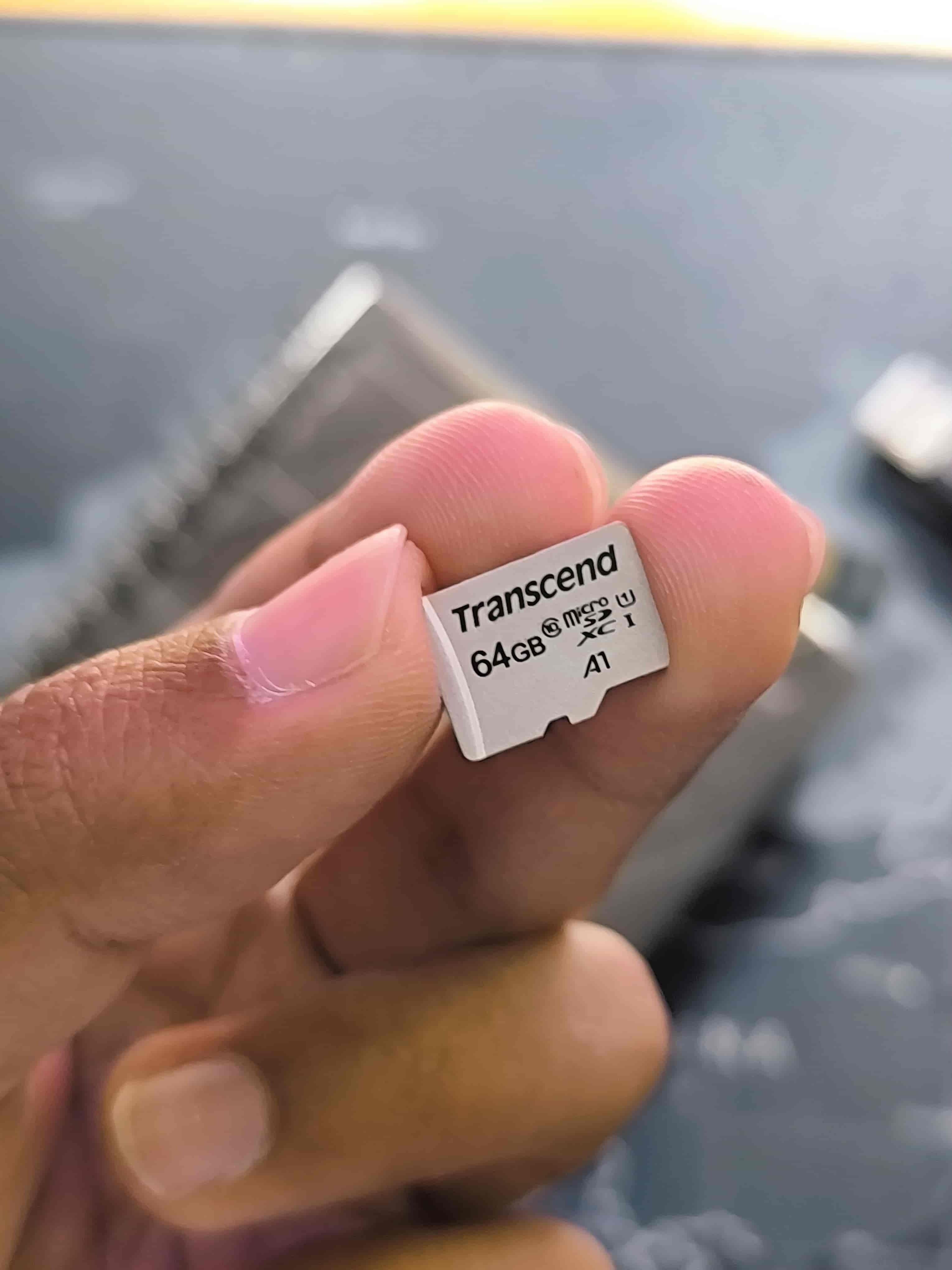 A person holding a micro SD card