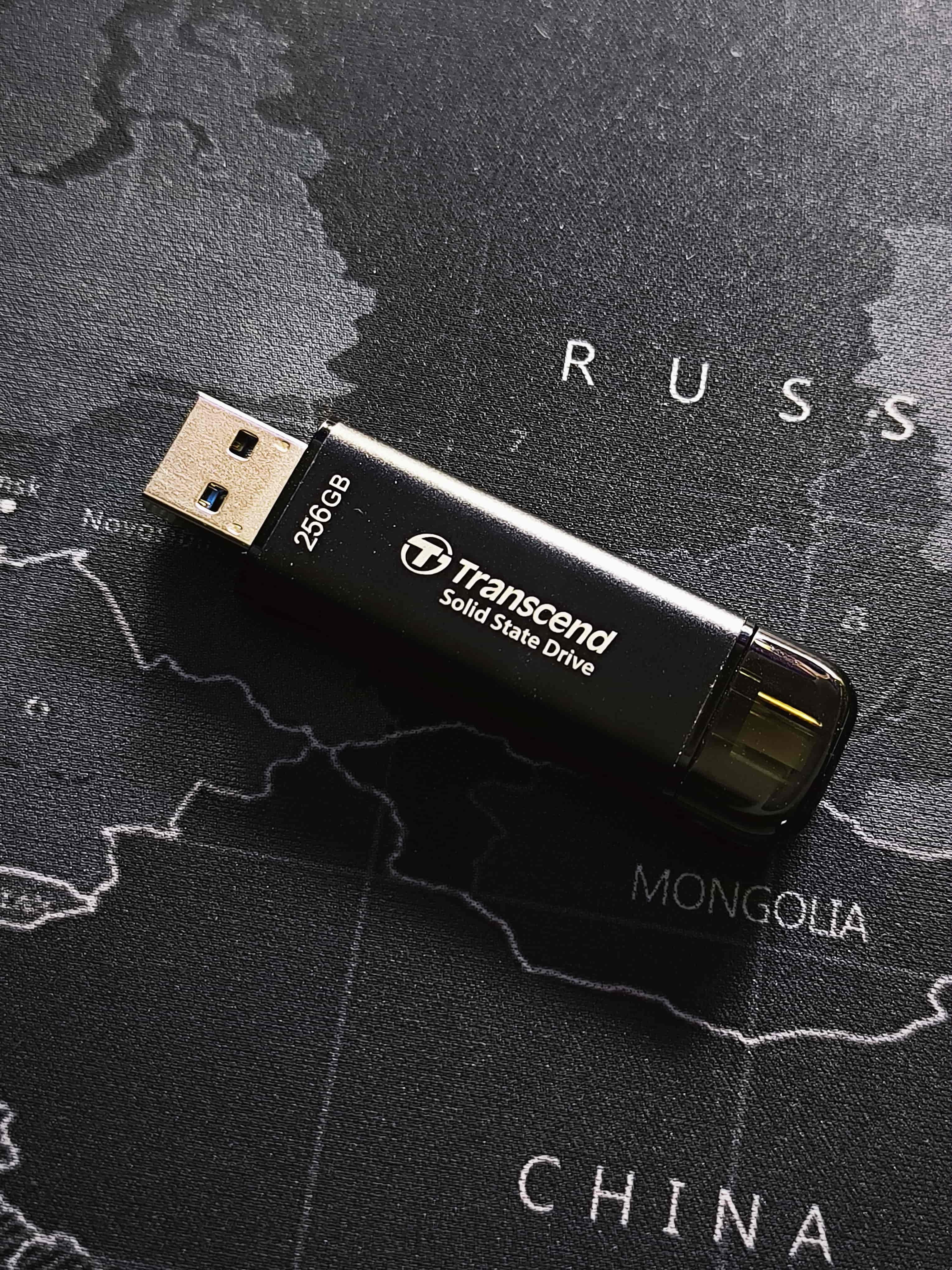 A person holding a pendrive-shaped SSD