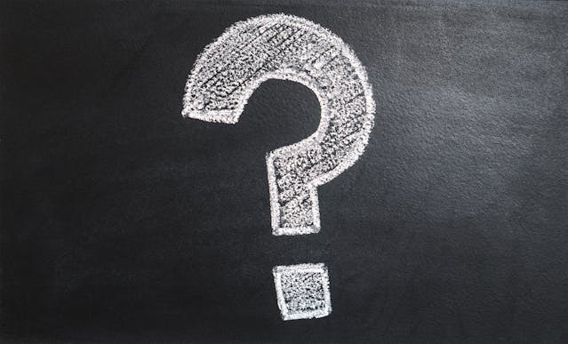a question mark written on a chalk board